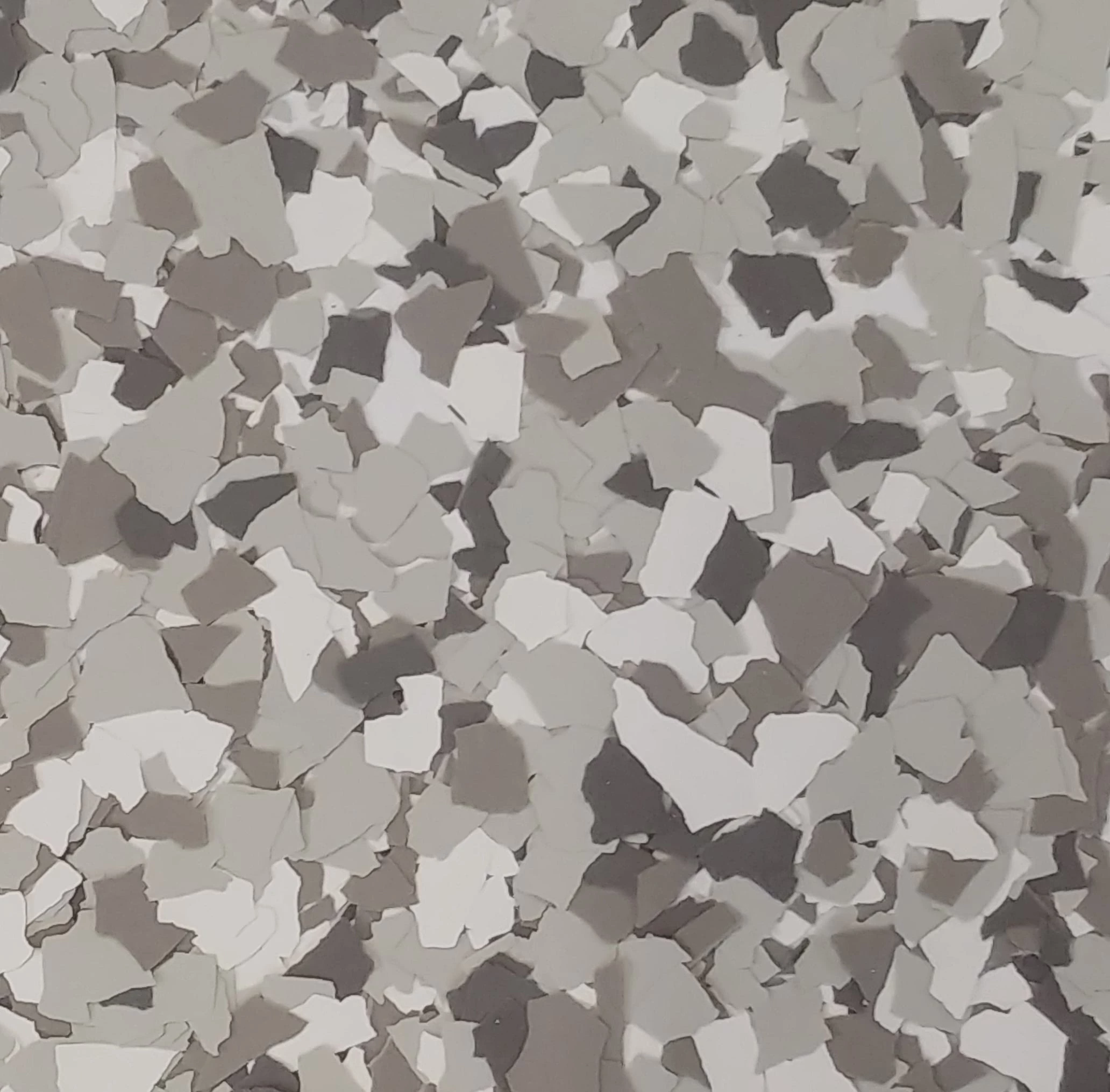 A gray and white background with small pieces of paper.