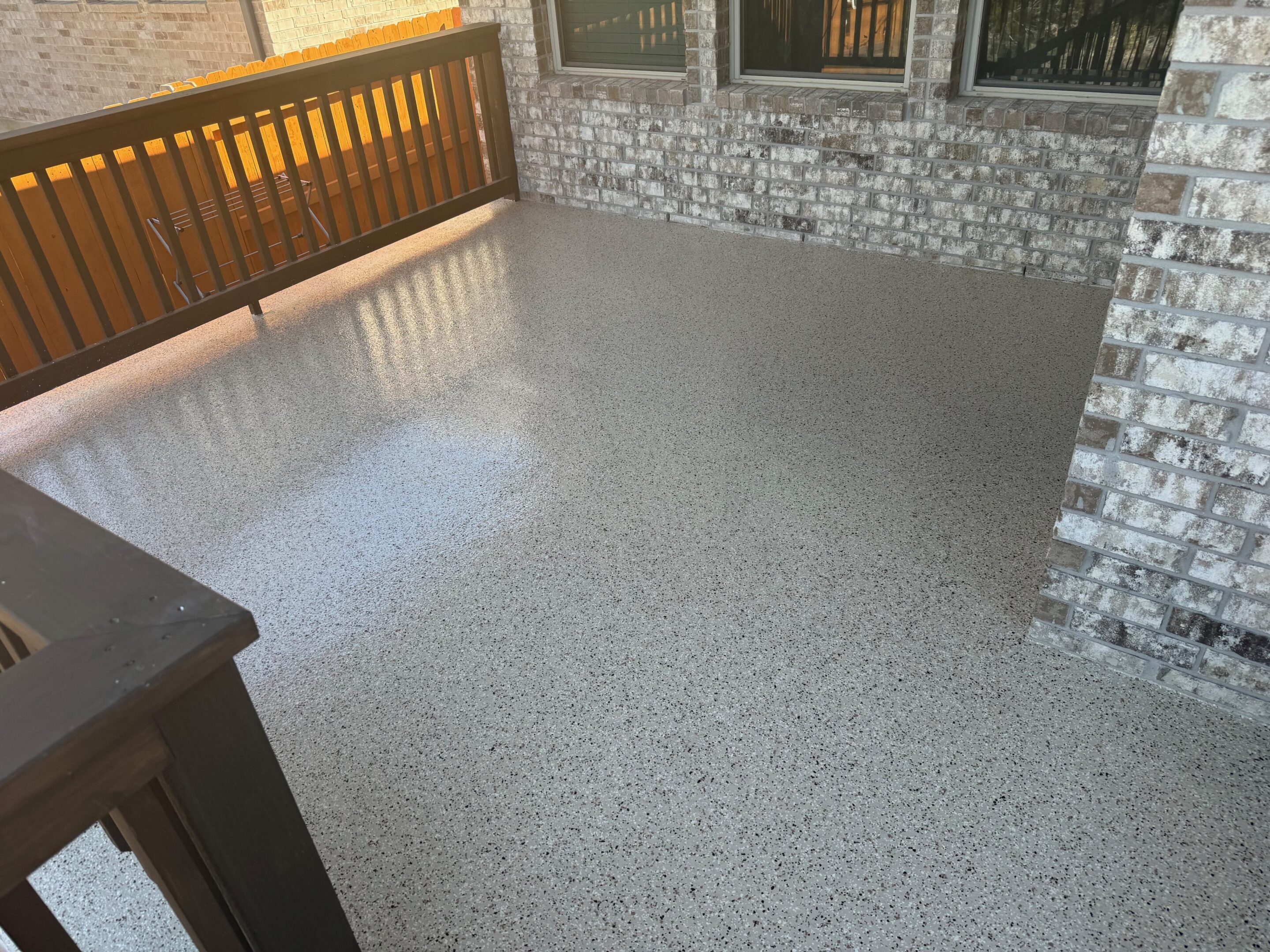 A room with a balcony and a floor that has been cleaned.