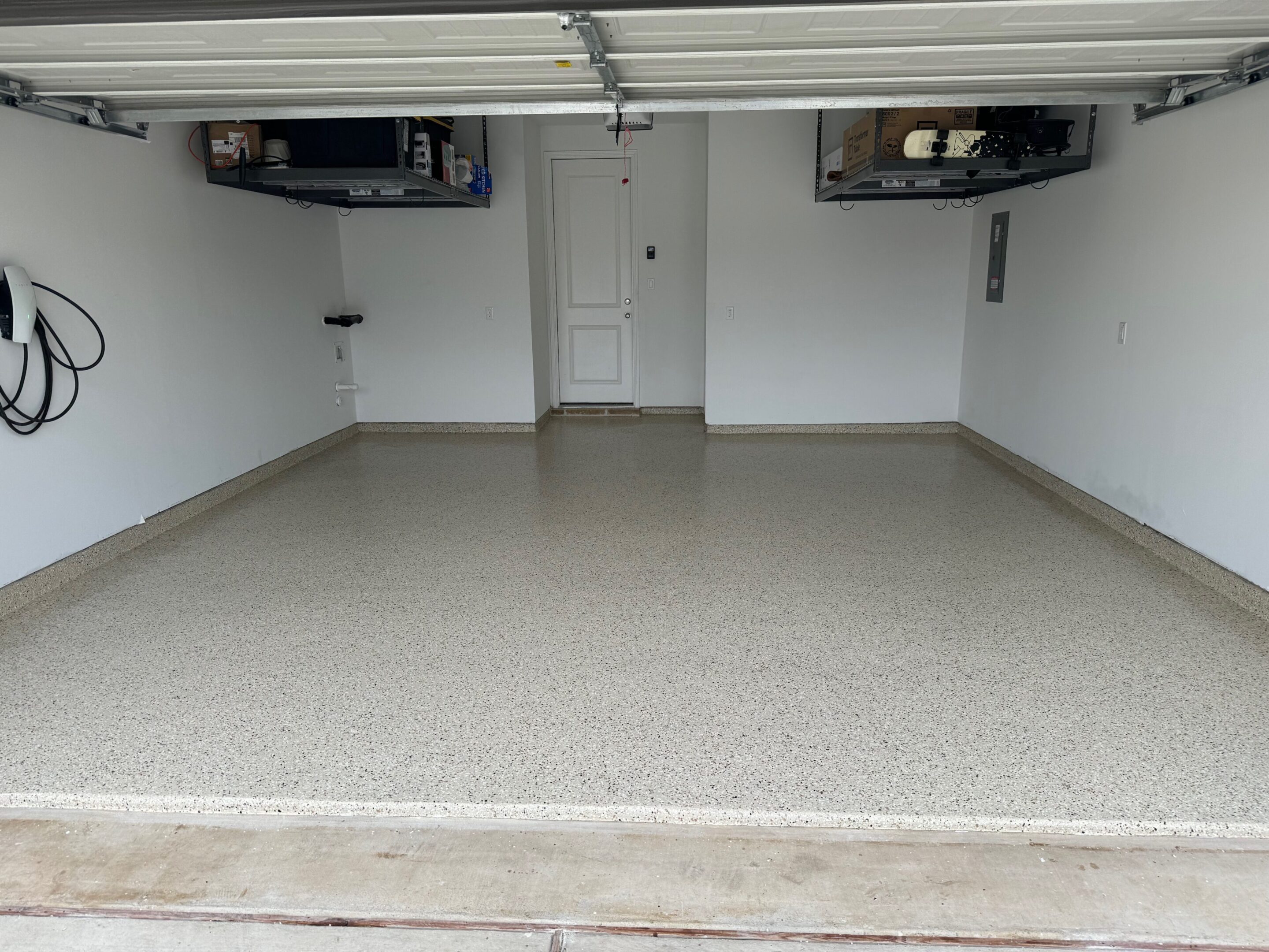 A garage with two shelves and a door.