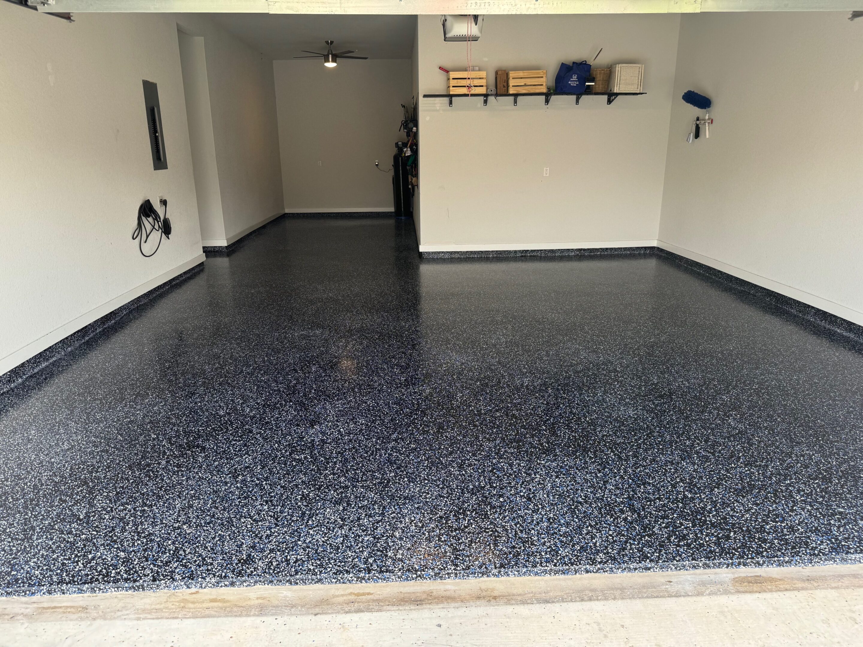 A garage with a black floor and white walls