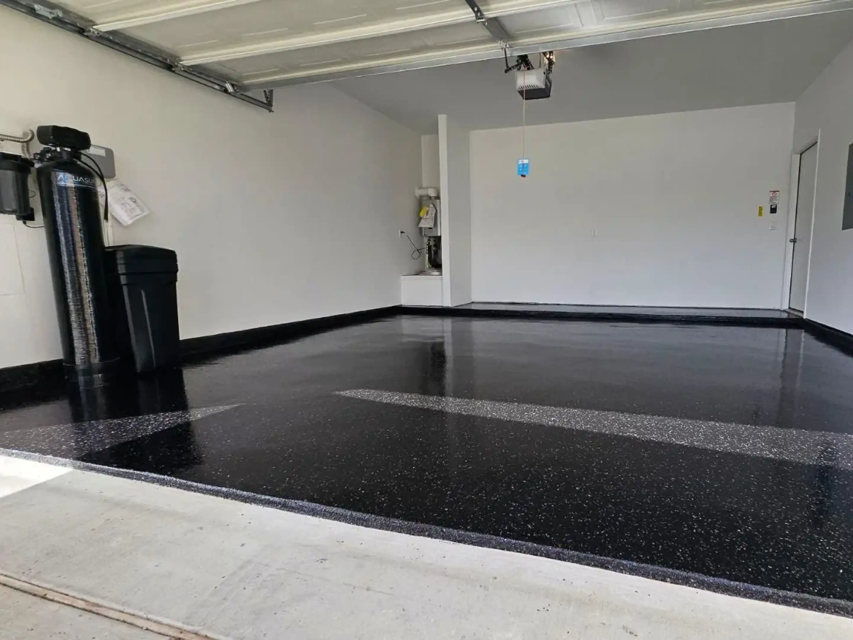 A garage with black and white floor in it